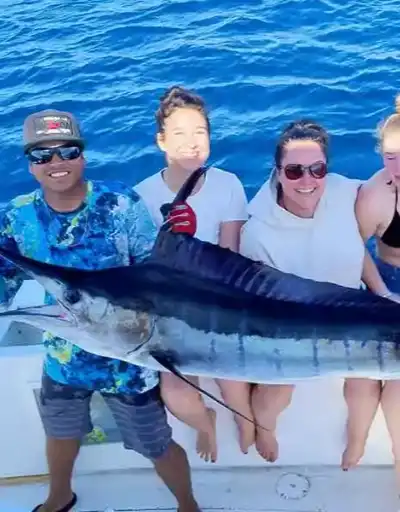 Angler fighting a big fish on a deep sea fishing charter off Cabo.