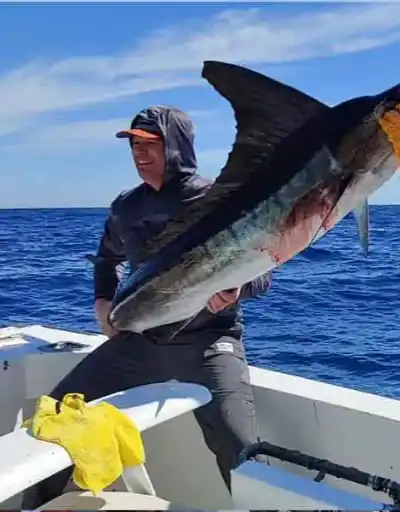 Happy clients with their catch of the day in Cabo San Lucas.