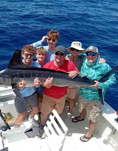 Two anglers proudly displaying a wahoo fish.